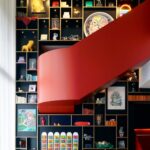 Red staircase against the curated bookshelf wall at citizenM Washington DC Capitol